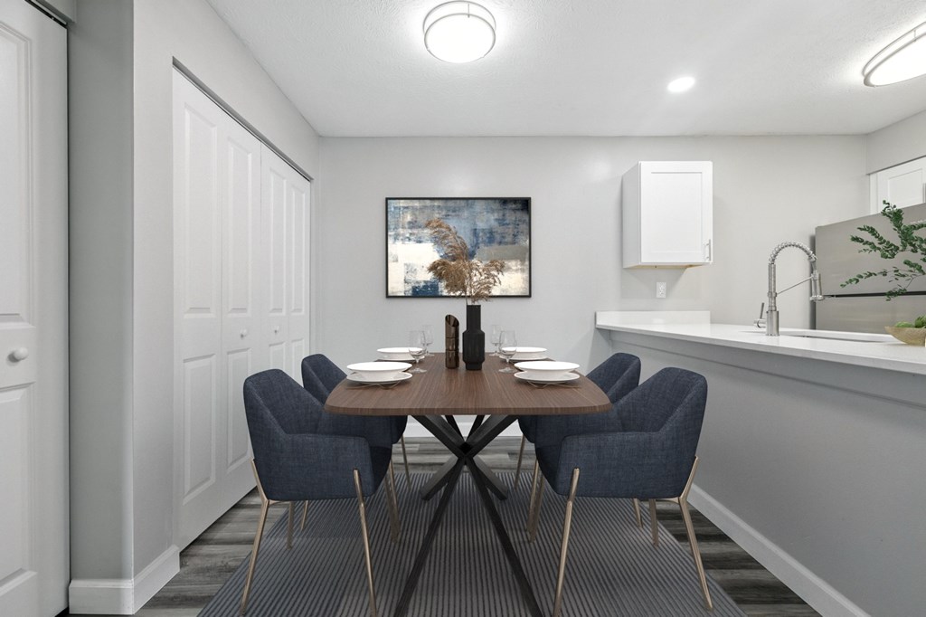A dining room with a wooden table and blue chairs.
