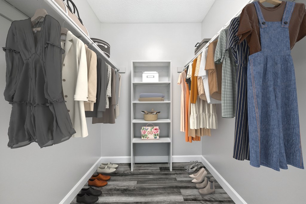 A room with a closet full of clothes and a shelf with baskets and boxes.