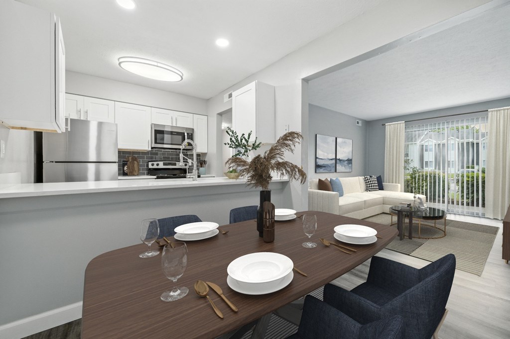 A modern dining room with a wooden table set for two.