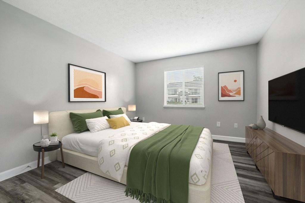 A bedroom with a large bed and a TV on the wall.