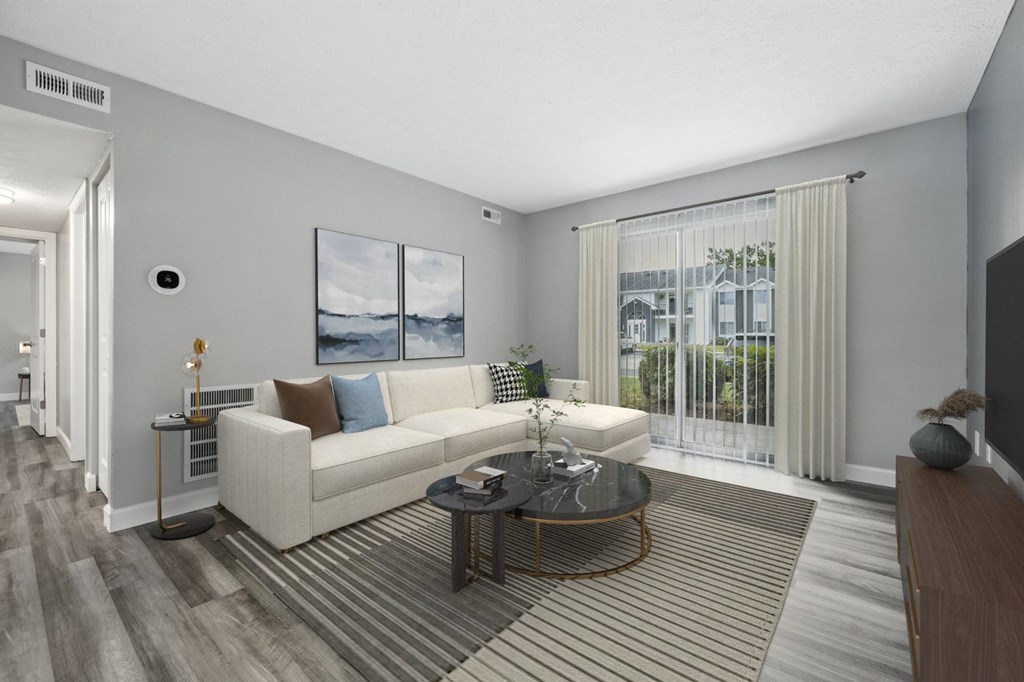 A living room with a white couch and a coffee table.