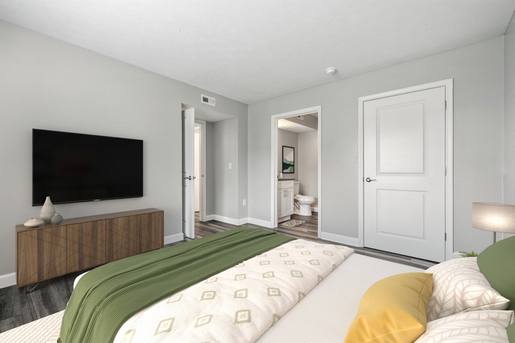 A bedroom with a bed, a television, and a cabinet.