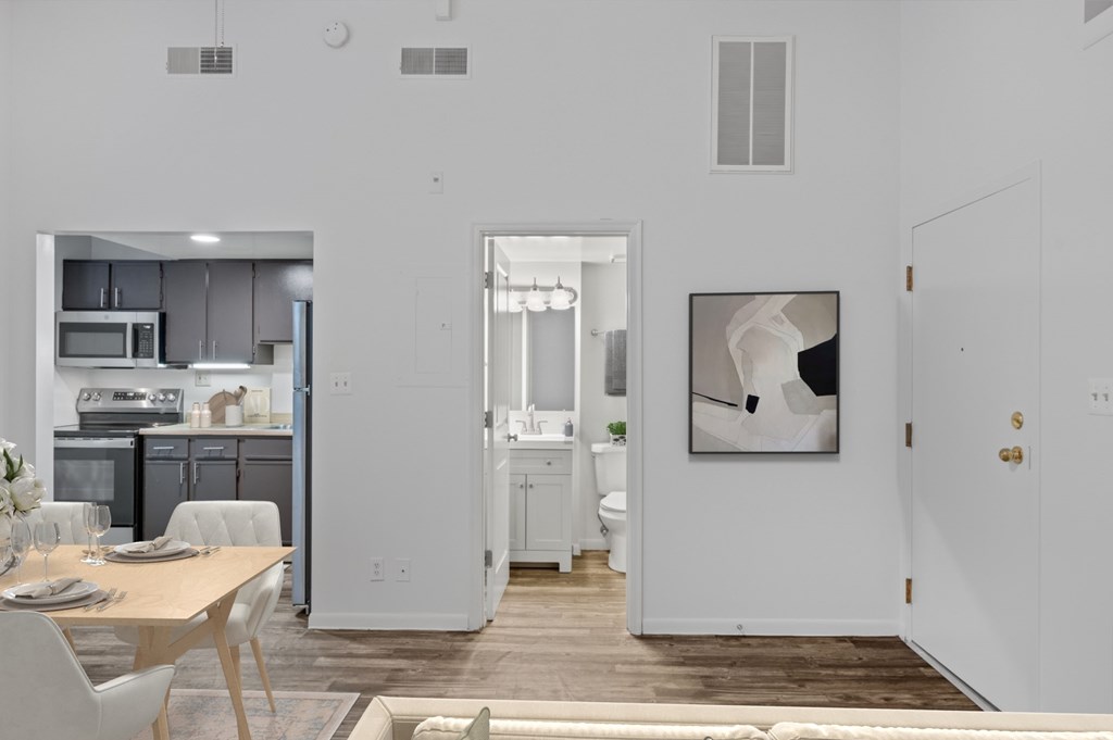 A modern kitchen with a dining table and chairs.