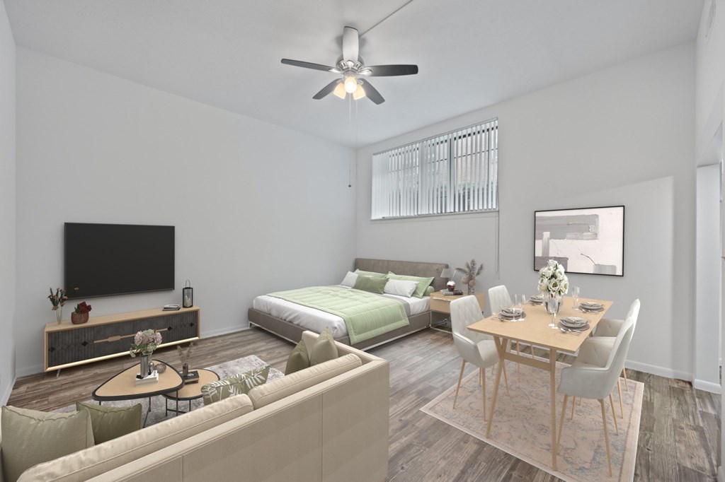 A modern living room with a television, a bed, and a dining table.