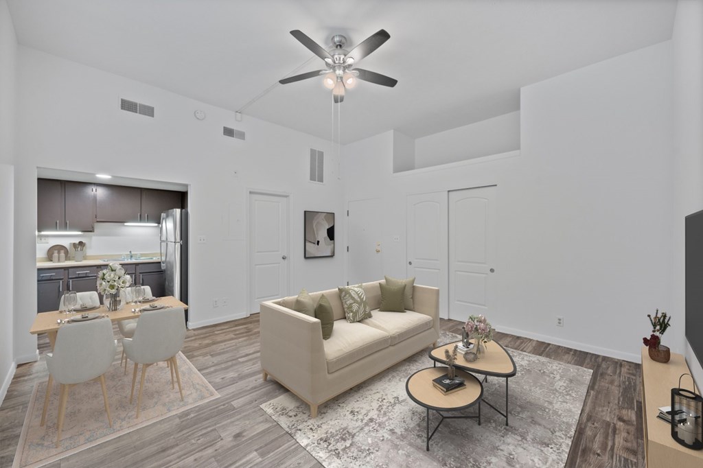 A living room with a couch, chairs, and a coffee table.