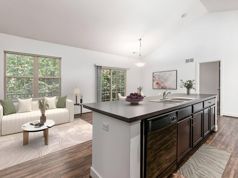 A modern kitchen with dark wood cabinets and a white island.