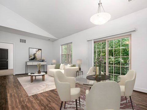 A modern dining room with a glass table and white chairs. at River View at Bexley Apartments, River View at Bexley, Ohio