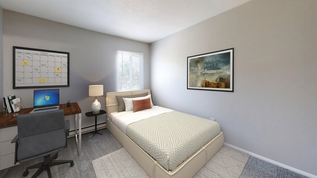 A bedroom with a bed, desk, and chair.