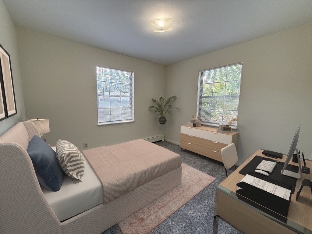 A bedroom with a bed, desk, and chair.