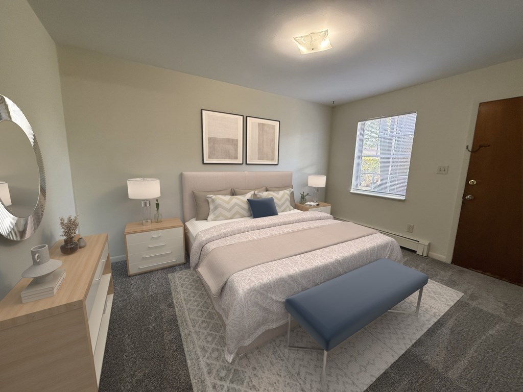 A bedroom with a large bed and a blue ottoman.