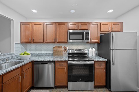 A kitchen with wooden cabinets and stainless steel appliances.
