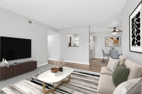 A living room with a white couch and a coffee table.