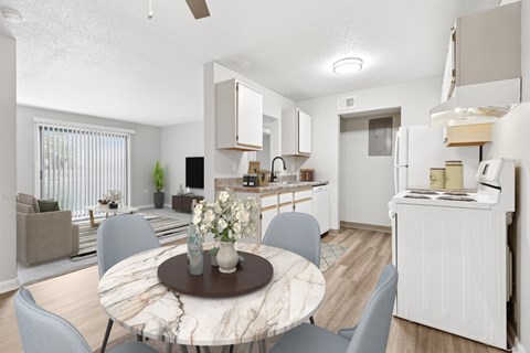 A modern kitchen with a dining table set in the middle.