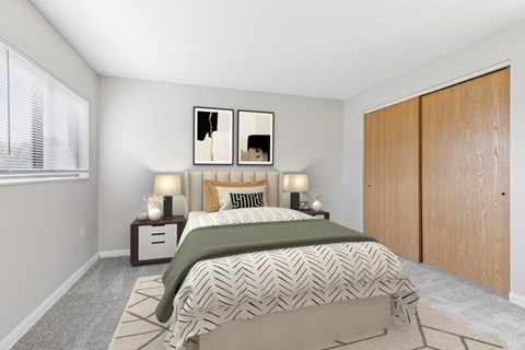 A bedroom with a bed, two nightstands, and a painting on the wall.