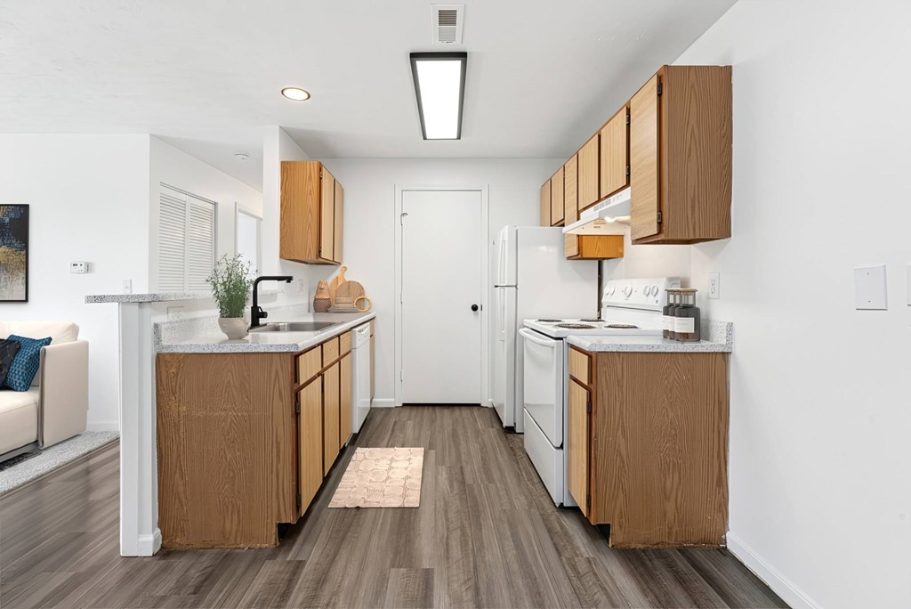 A kitchen with wooden cabinets and a white refrigerator.
