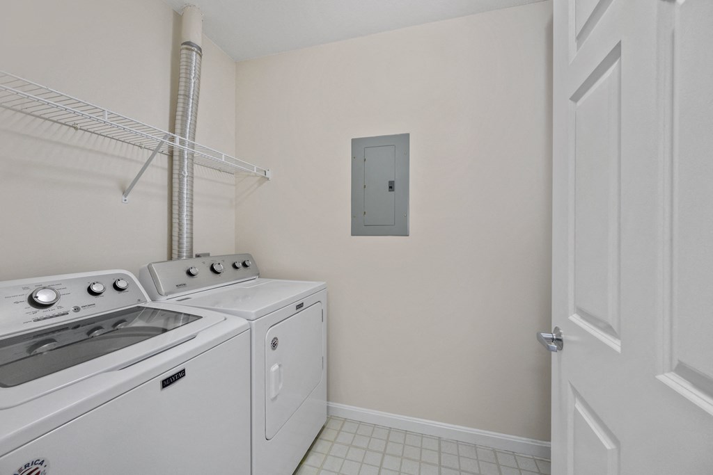 a white kitchen with a white stove and a white door
