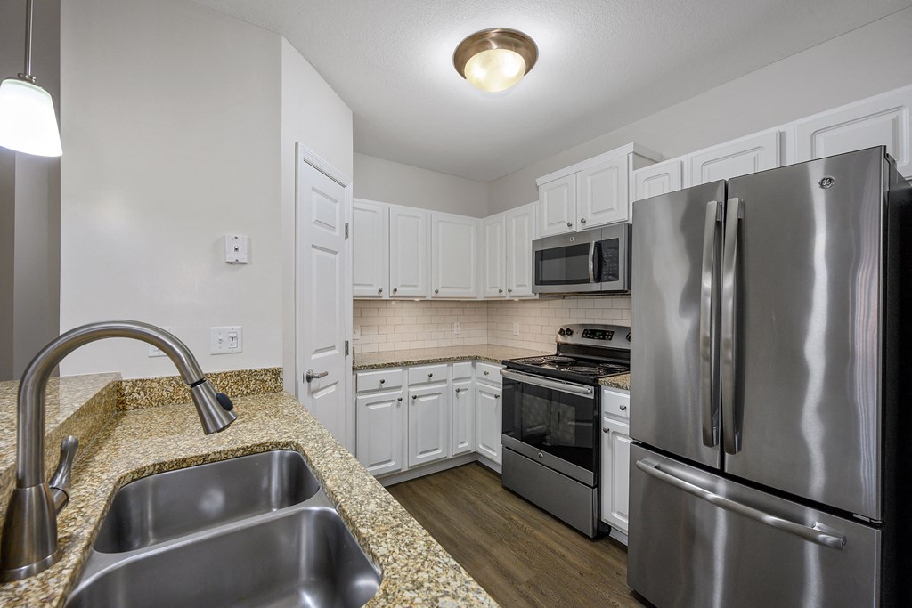 a kitchen with stainless steel appliances and a granite counter top