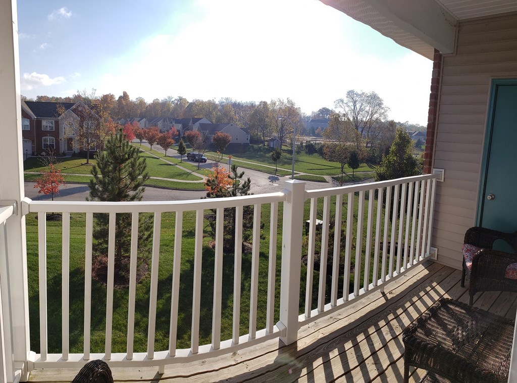 A view from a balcony overlooking a suburban neighborhood.
