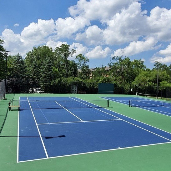 Blue and green tennis court with a blue sky at Indian Creek Apartments, Cincinnati, OH, 45236