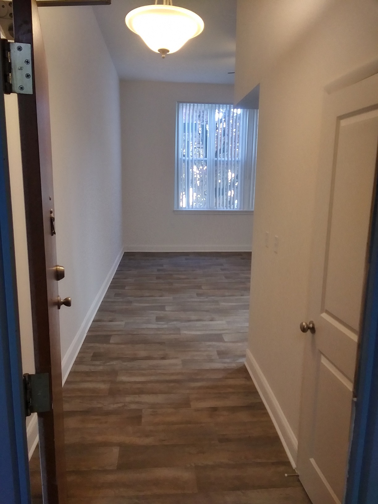 a room with a hallway and a window and a door