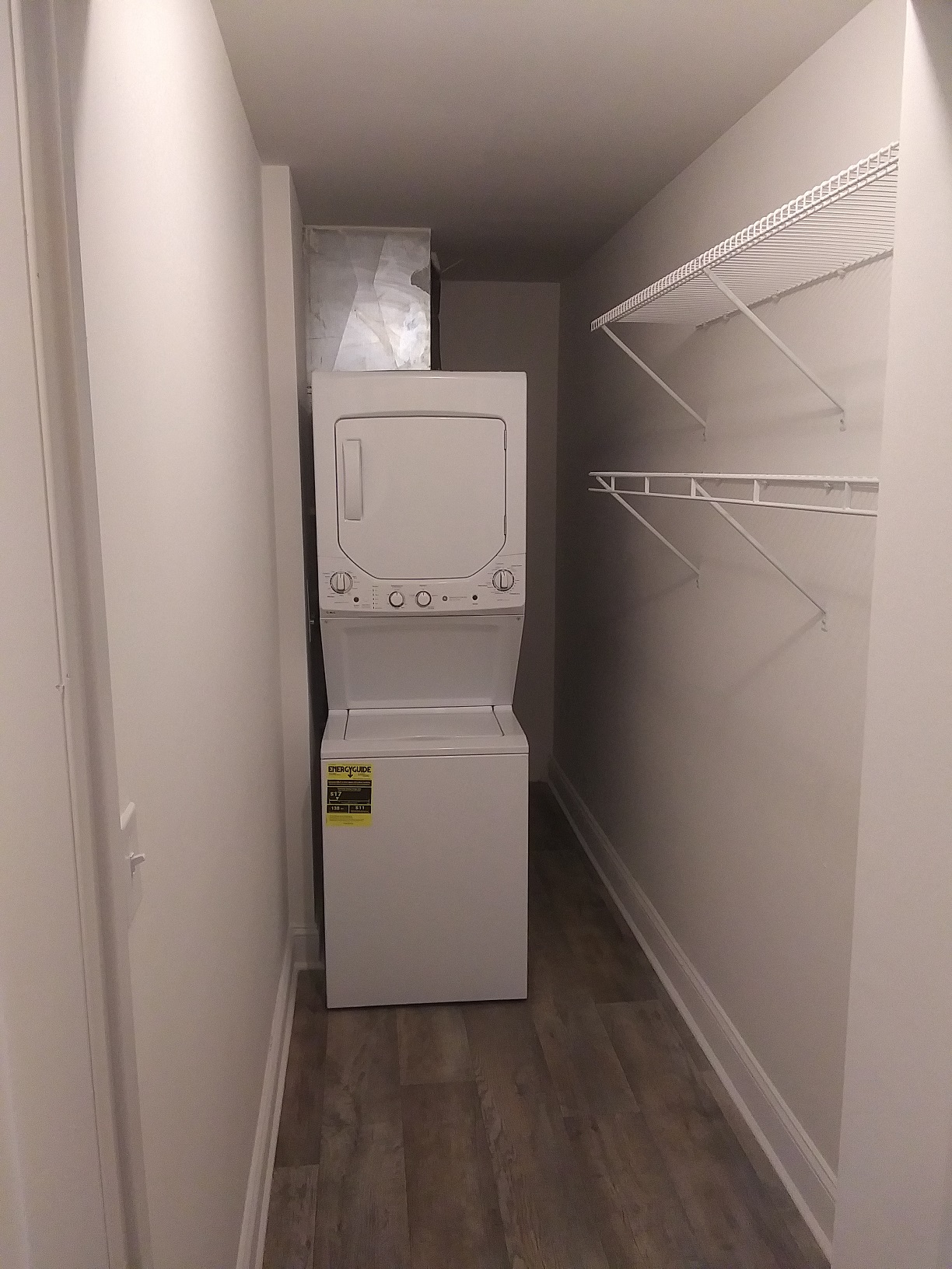 a white washer and dryer in a white closet