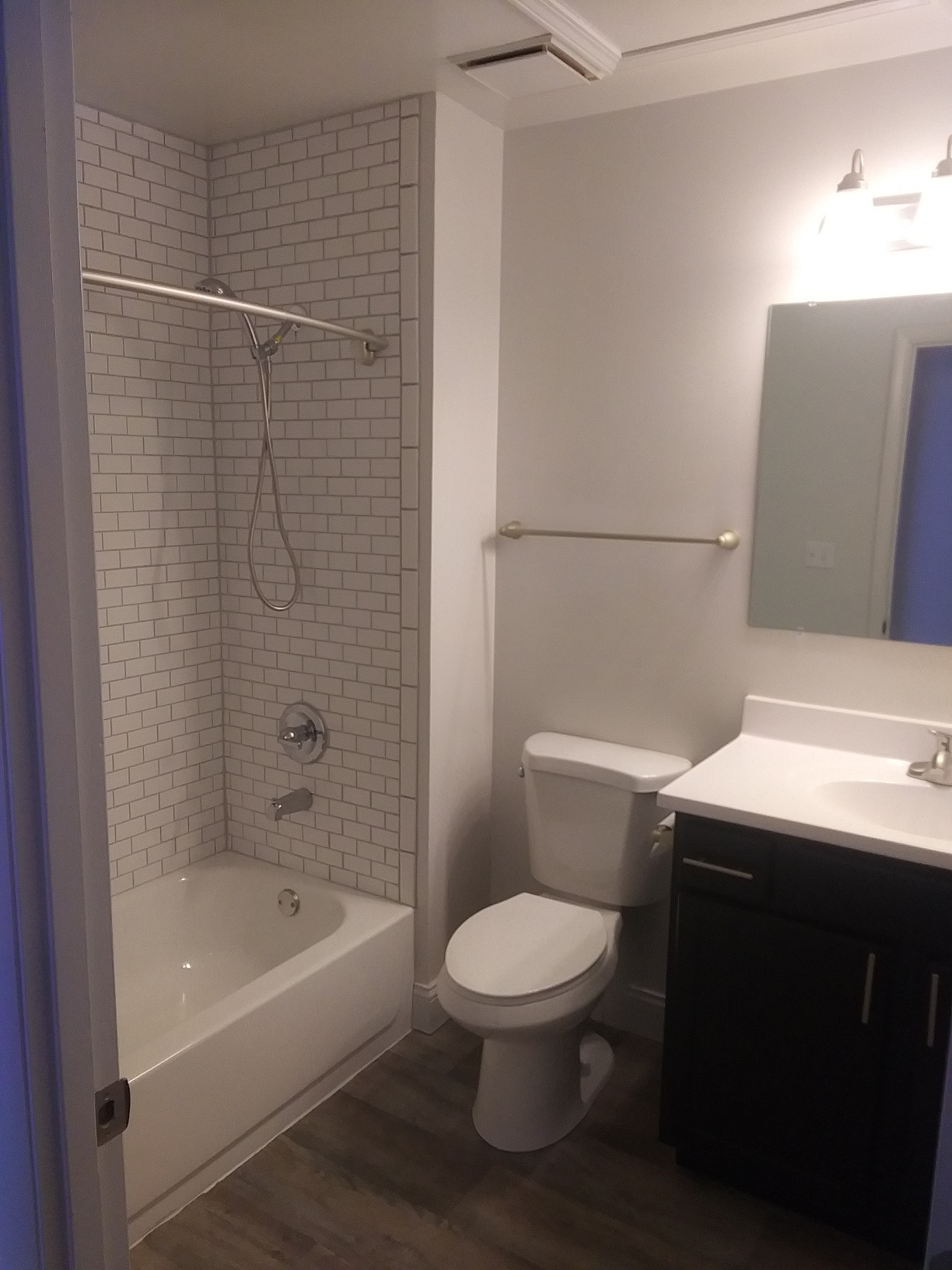 a small bathroom with a shower toilet and sink