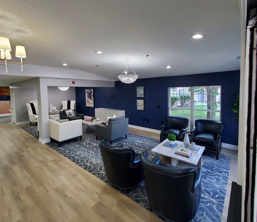 a view of a living room with couches and chairs