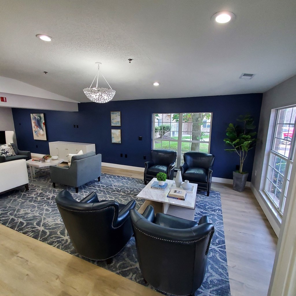 a communal room with chairs and couches and a table