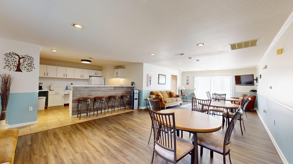 A kitchen with a dining table and chairs.