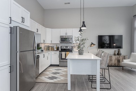a kitchen with stainless steel appliances and a white table