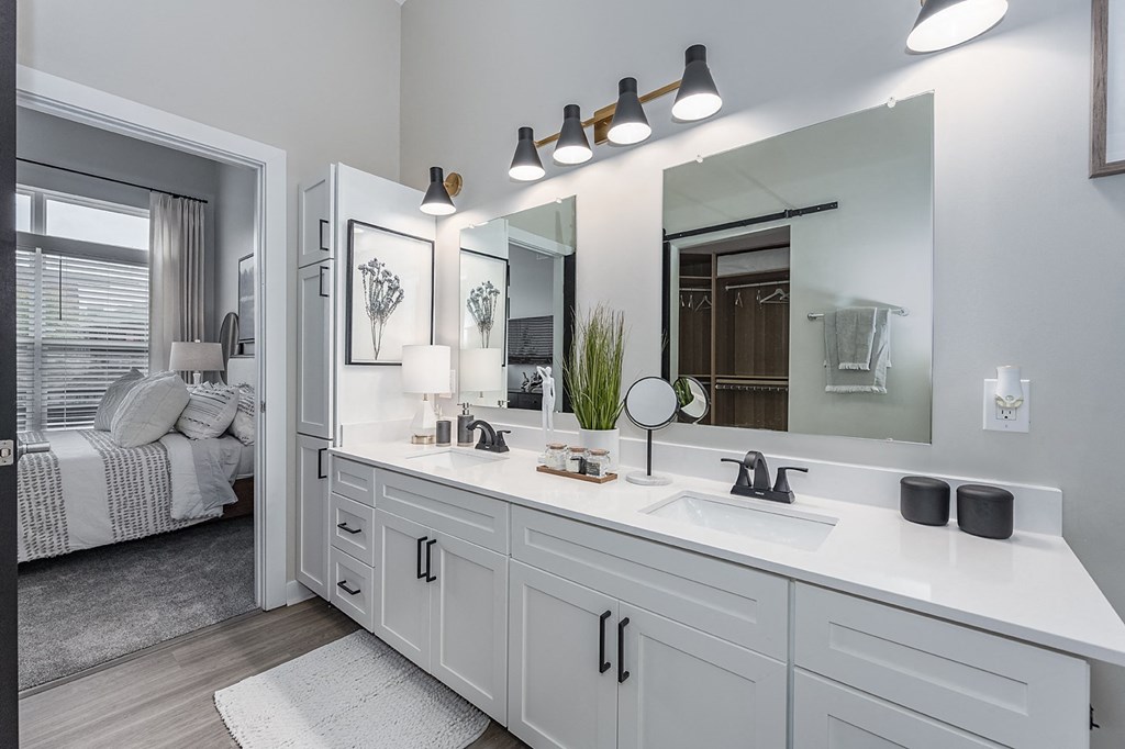 1-Bedroom Apartments in Liberty Township, OH - Liberty Center - Attached Bathroom with Double Vanity Sinks and Mirrors, White Quartz Countertops, and White Cabinets.