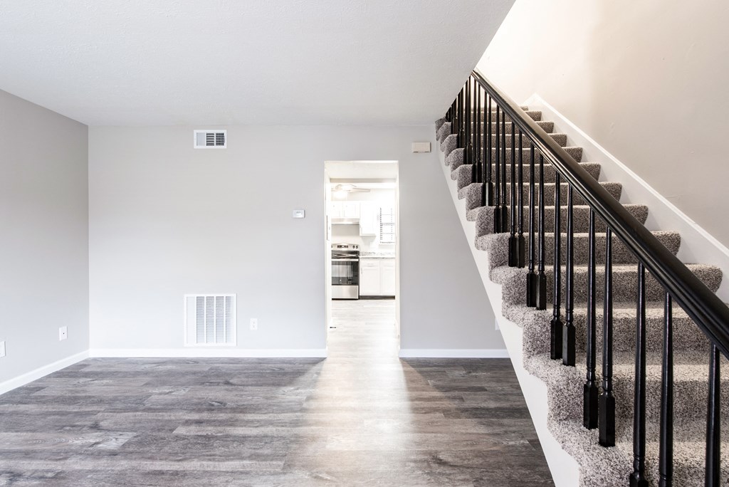 a staircase in a new home with white walls and wood floors