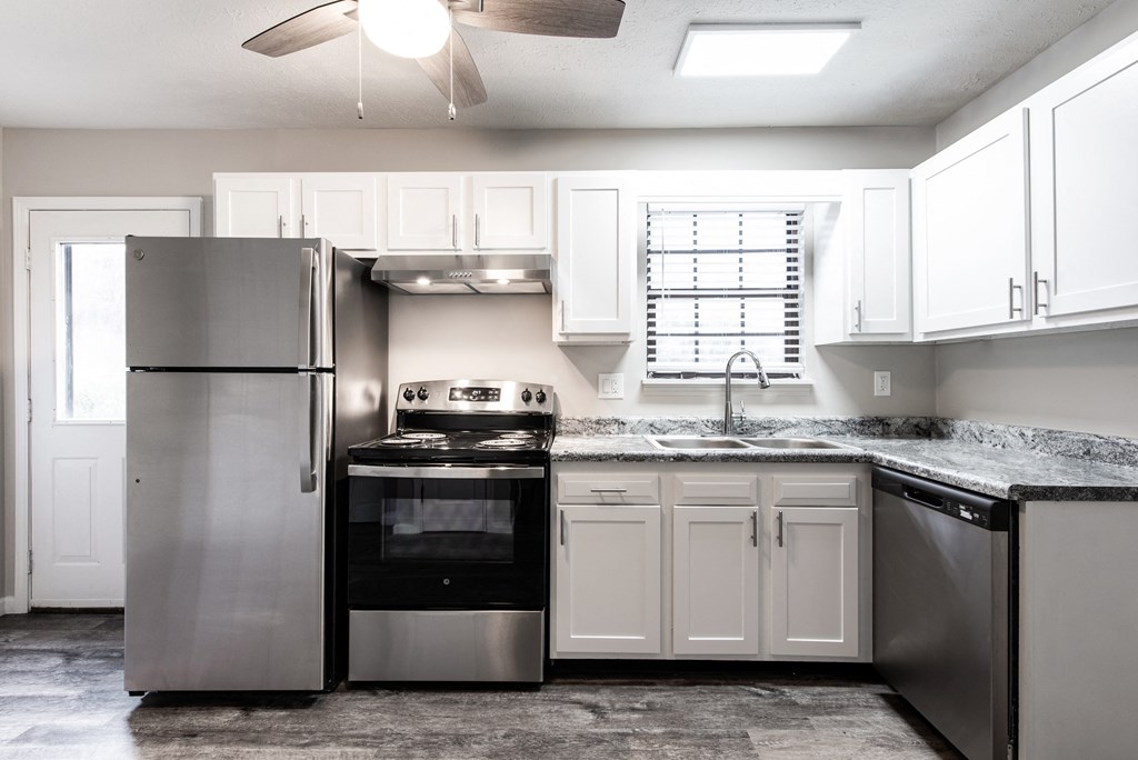 a kitchen with stainless steel appliances and white cabinets