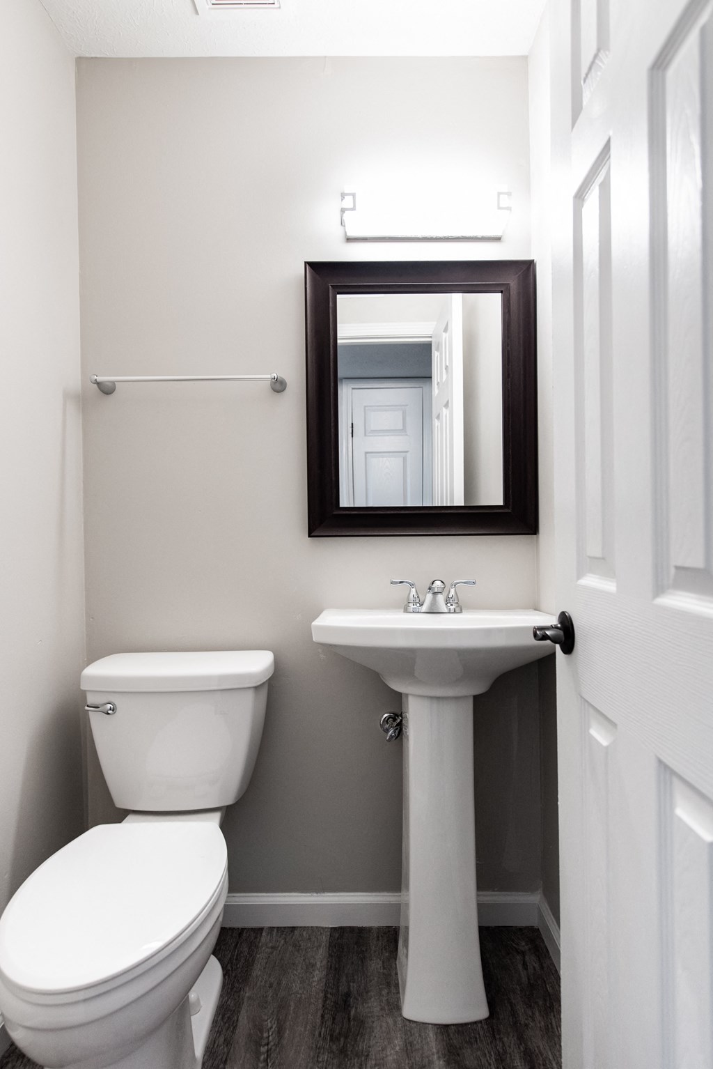 a small bathroom with a toilet sink and mirror
