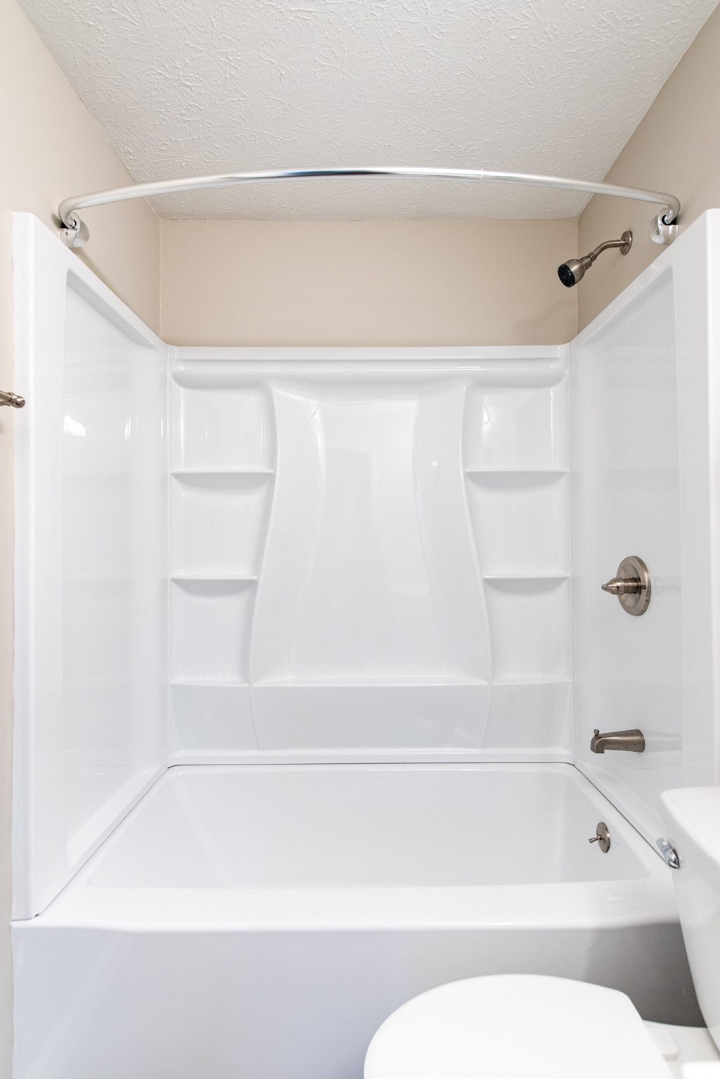 a white bathroom with a tub and a toilet