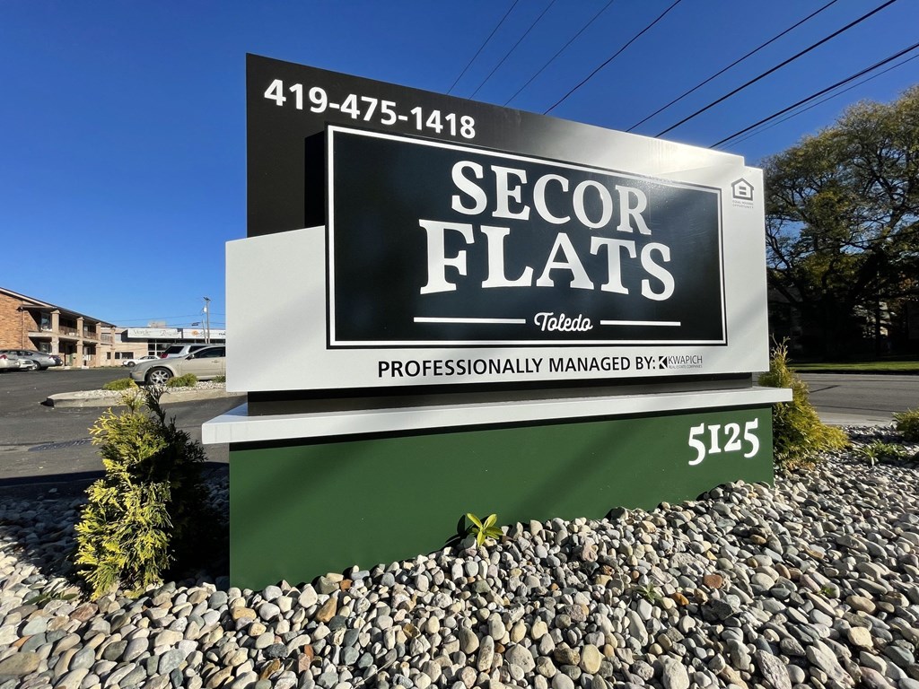 a sign in front of a building that says sector flats