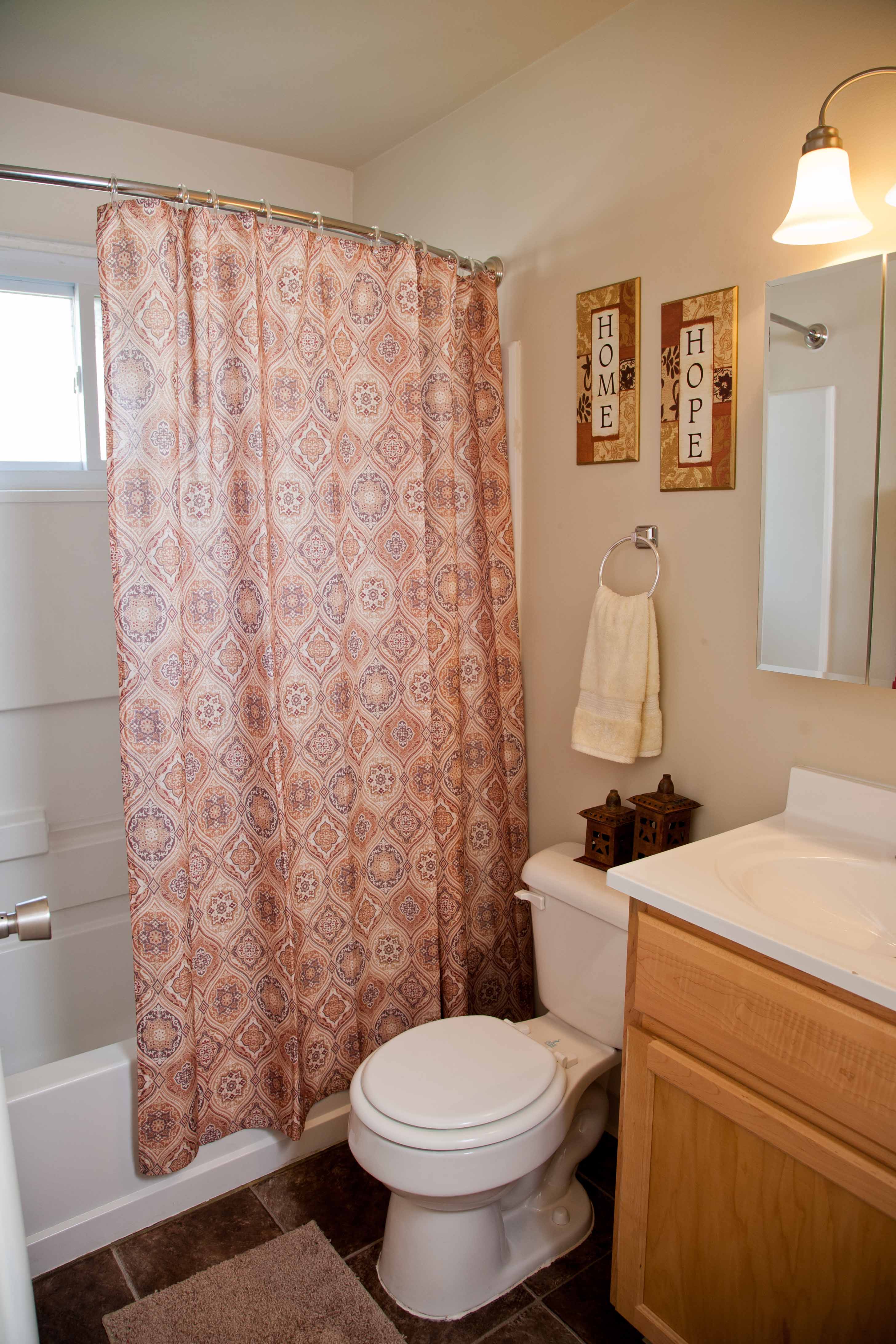 a bathroom with a toilet and a shower curtain
