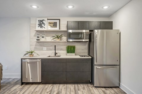 a kitchen with stainless steel appliances and a stainless steel refrigerator