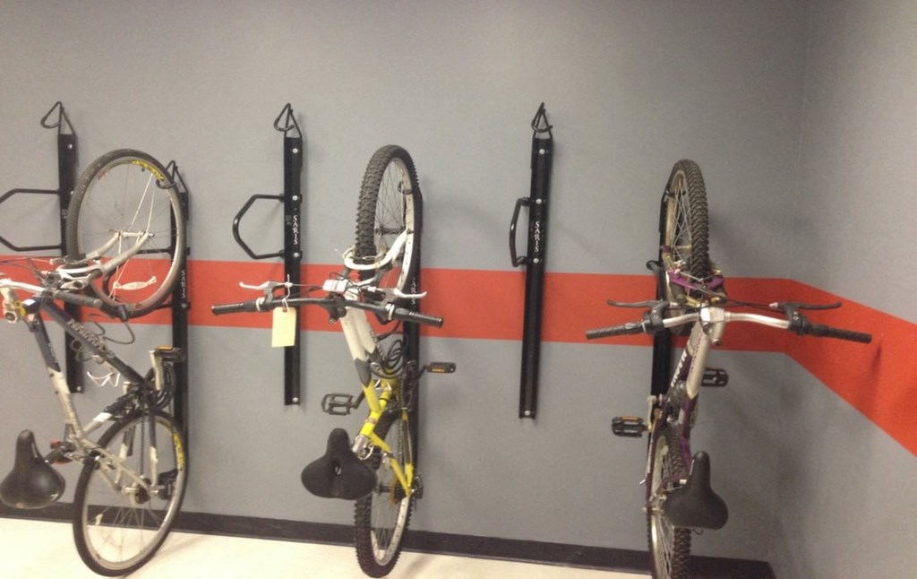 a wall mounted bike rack with several bikes on it