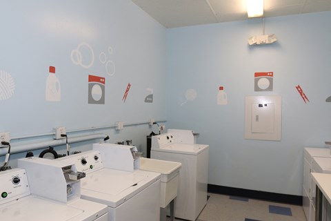 a group of washing machines in a laundry room