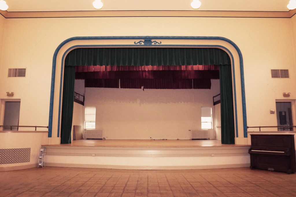 the view of the stage from the balcony of the auditorium
