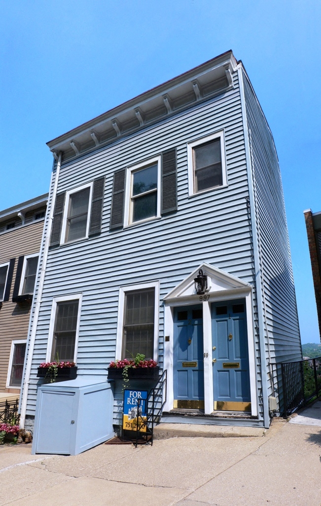 the front of a house with a blue door