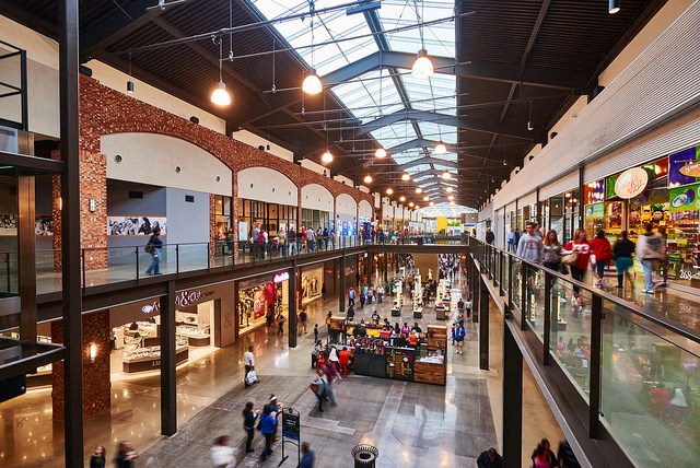 a large shopping mall with people walking through it