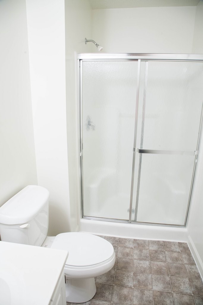 a bathroom with a toilet and a shower