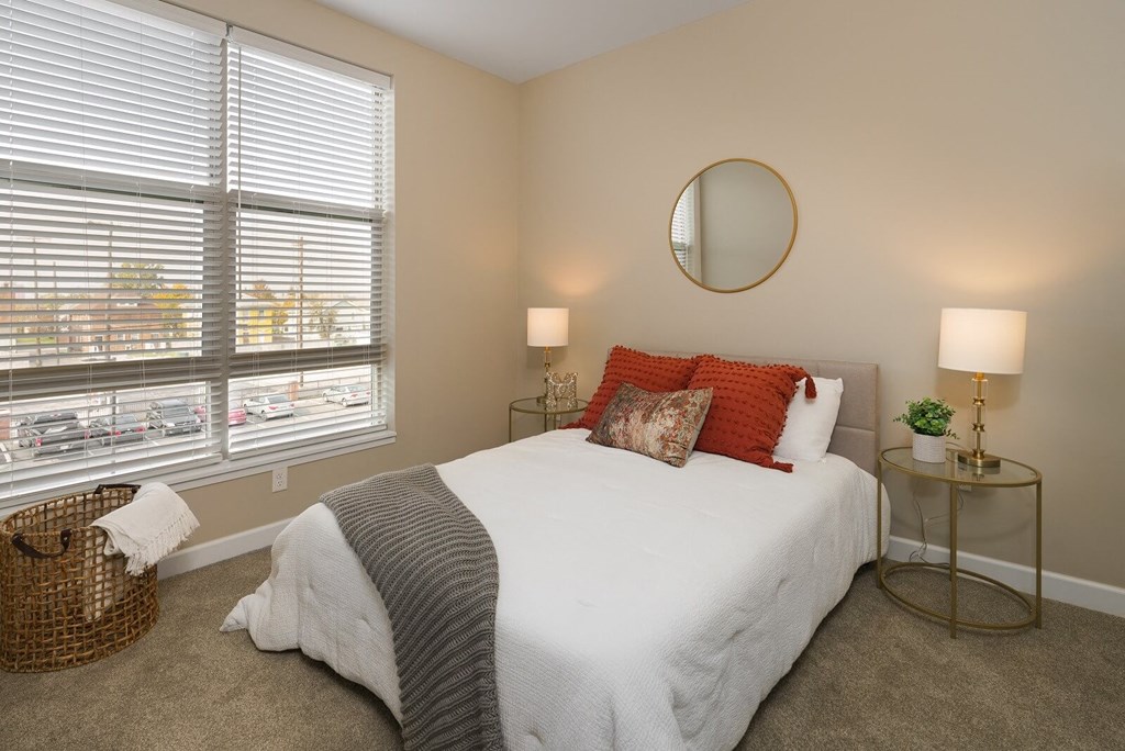 a bedroom with a white bed and two windows at Adelphi Quarter, Columbus, 43203