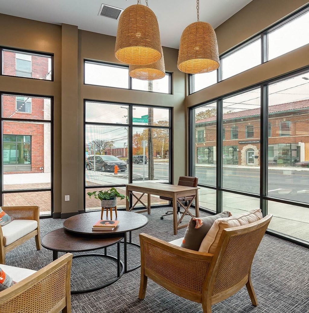 a lobby with chairs and tables and large windows at Adelphi Quarter, Columbus