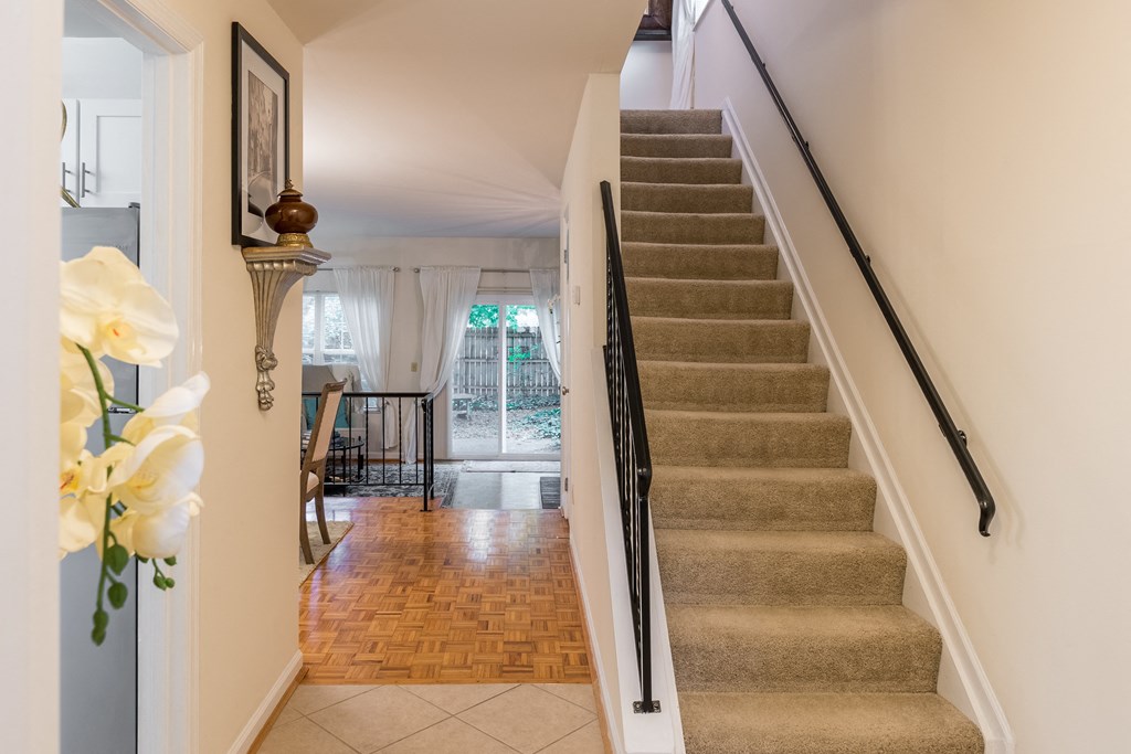 Staircase in a house with a view of a dining room and a living room at Indian Creek Apartments, Ohio