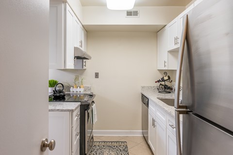 Open kitchen with stainless steel appliances and white cabinets at Indian Creek Apartments,  45236