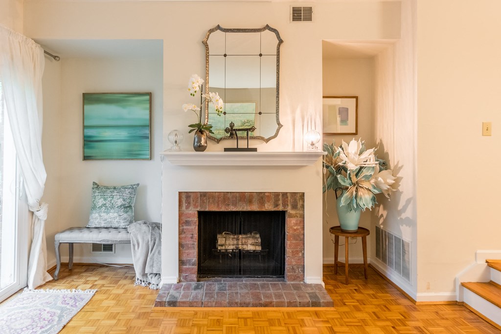 Living room with a fireplace and a mirror on the wall at Indian Creek Apartments, 45236