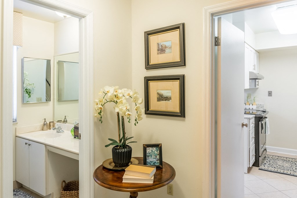 Bathroom with a sink and a mirror and a table with some flowers at Indian Creek Apartments, Cincinnati, OH, 45236